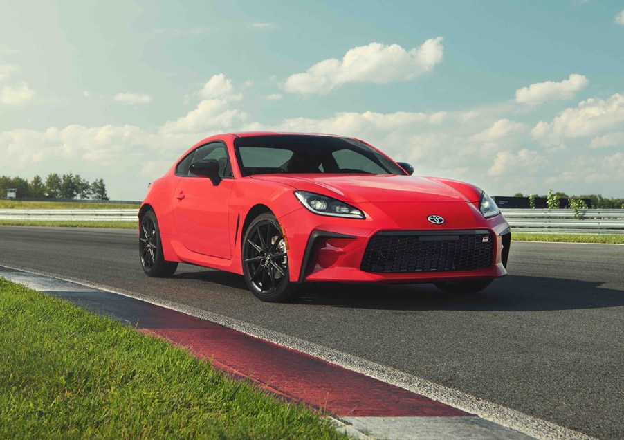 2022 Toyota GR86 in red driving on a track toward the right side of the image frame.