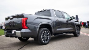 This is a photo of a gray 2022 Toyota Tundra pickup truck with a iForce MAX hybrid drivetrain, shared by a 2022 Toyota Tundra Capstone, at a test event. | Bill Pugliano/Getty Images