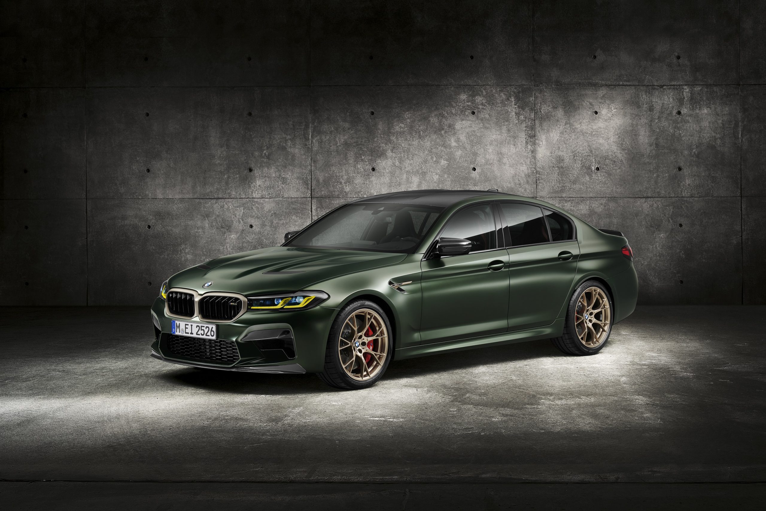 The matte green 2022 BMW M5 CS shot from the front 3/4