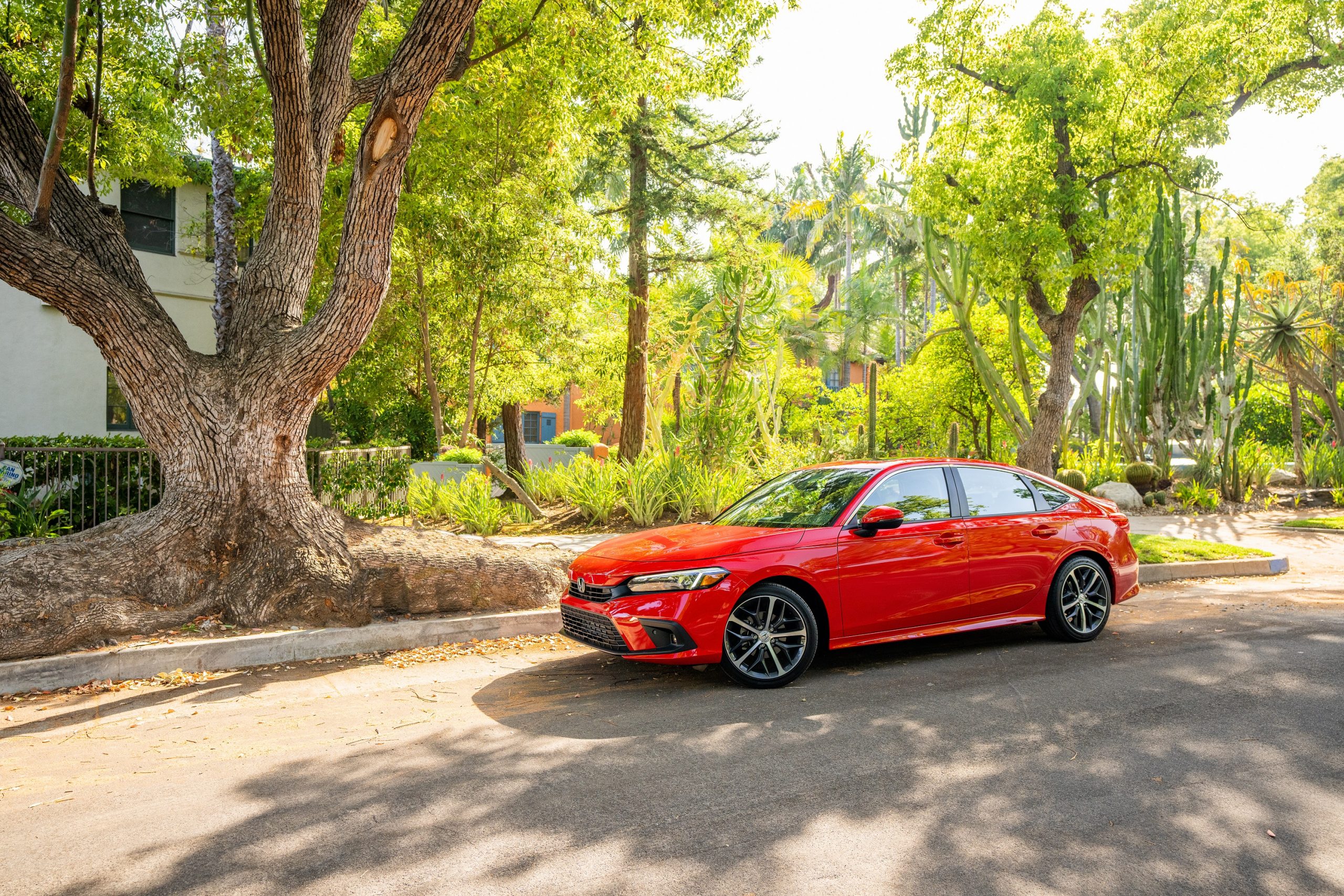 A red 2022 Honda Civic sedan parked on a city street