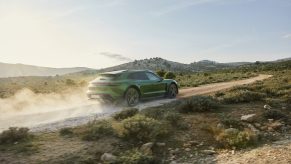 A green 2022 Porsche Taycan CrossTurismo off-road