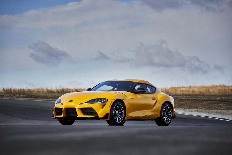 A yellow 2022 Toyota Supra 2.0 shot from the 3/4 angle on a racetrack