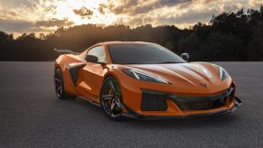 An orange 2023 Chevrolet Corvette Z06 shot from the front 3/4 at sunset