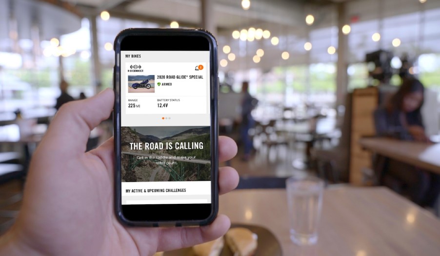 A 2020 Harley-Davidson Road Glide Special motorcycle rider accessing the Harley-Davidson App on their smartphone