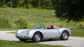 A silver-with-red-badging Beck 550 Spyder Replica by Chamonix Karosserie on a country road