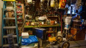 A silver lawn mower in storage in a garage