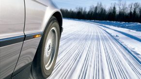 BMW With Winter Tires Driving Through Snow