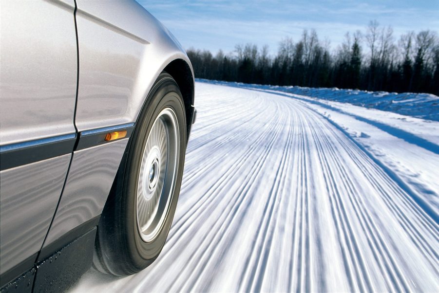 BMW With Winter Tires Driving Through Snow