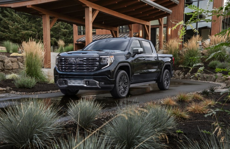 Black 2022 GMC Sierra 1500 Denali Ultimate parked in front of a house