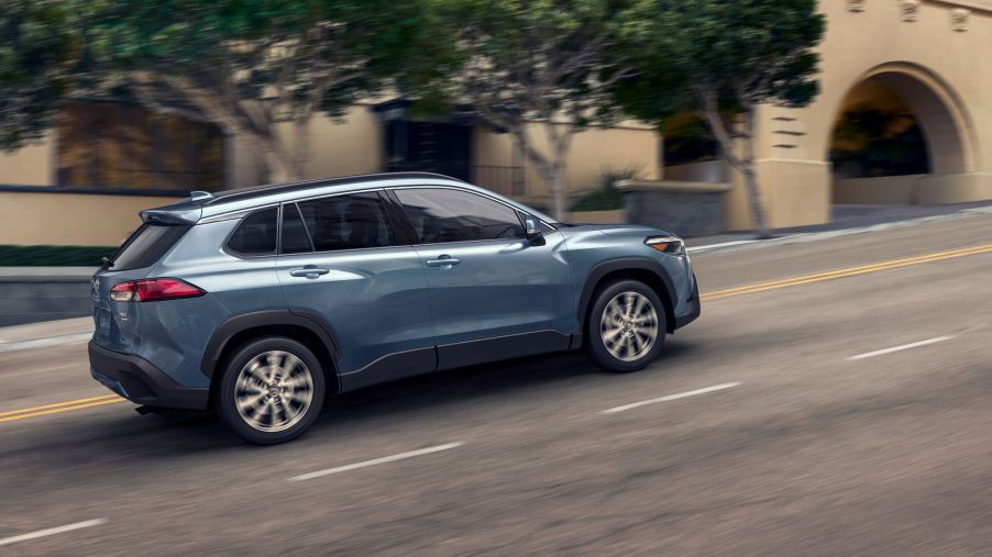 Blue 2022 Toyota Corolla Cross driving up a hill