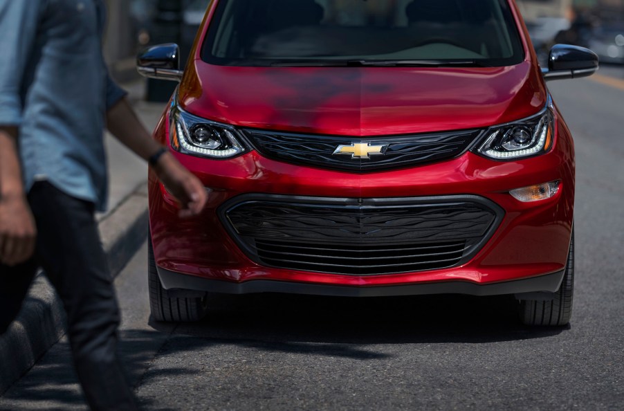 This is a promo photo of a red 2020 Chevrolet Bolt parked on the street. GM announced an additional Chevy Bolt recall, based on unsafe floormats. | General Motors