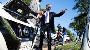 A Nissan Leaf being charged in Maryland by Rep. Anthony Brown and CEO of Washington Area New Dealers Association John O'Donnell