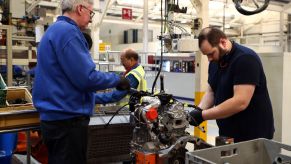 Ford employees working on a diesel engine at a factory in Dagenham, England