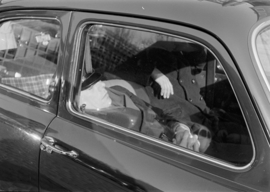 This is a photo of a man sleeping in a Volkswagen Beetle. Sleeping in your car is legal unless prohibited by local laws. | Erich Andres/United Images via Getty Images