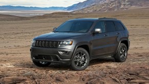 A gray 2021 Jeep Grand Cherokee parked on a plain.