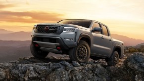 Gray 2022 Nissan Frontier parked on some rocks