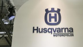 Husqvarna Motorcycles sign in blue on a white background.