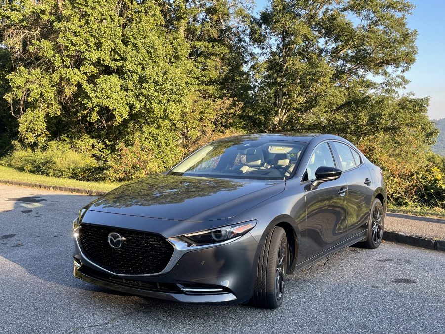 The 2021 Mazda3 Turbo parked in front of a mountain view