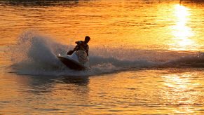 Jet ski on a water at sunset.