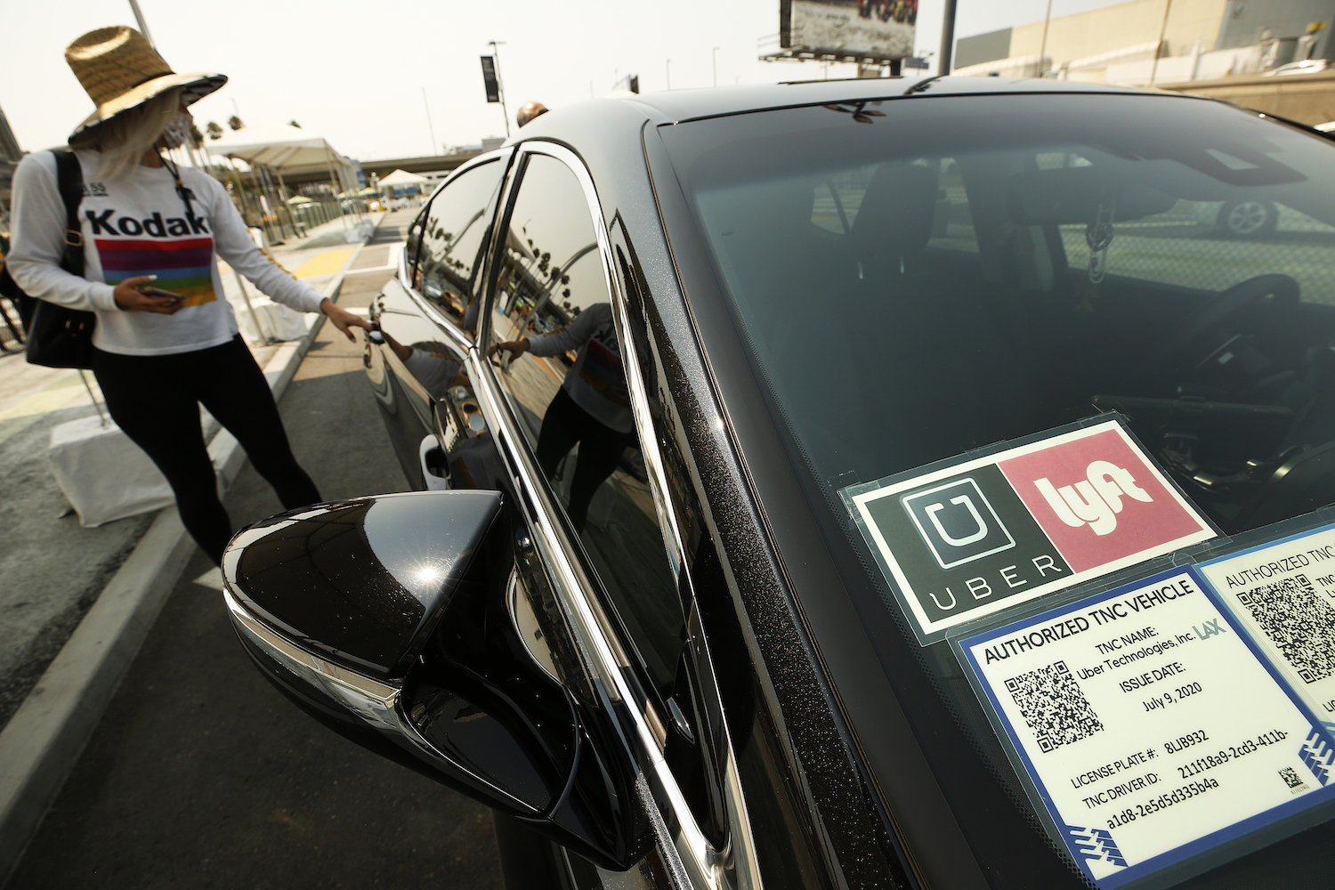 This is a photo of a woman getting into a rideshare vehicle. The Lyft and Uber safety divisions disclosed thousands of reported sexual assaults. | Al Seib/Los Angeles Times/Getty Images