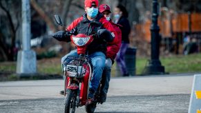 Men Riding On Moped