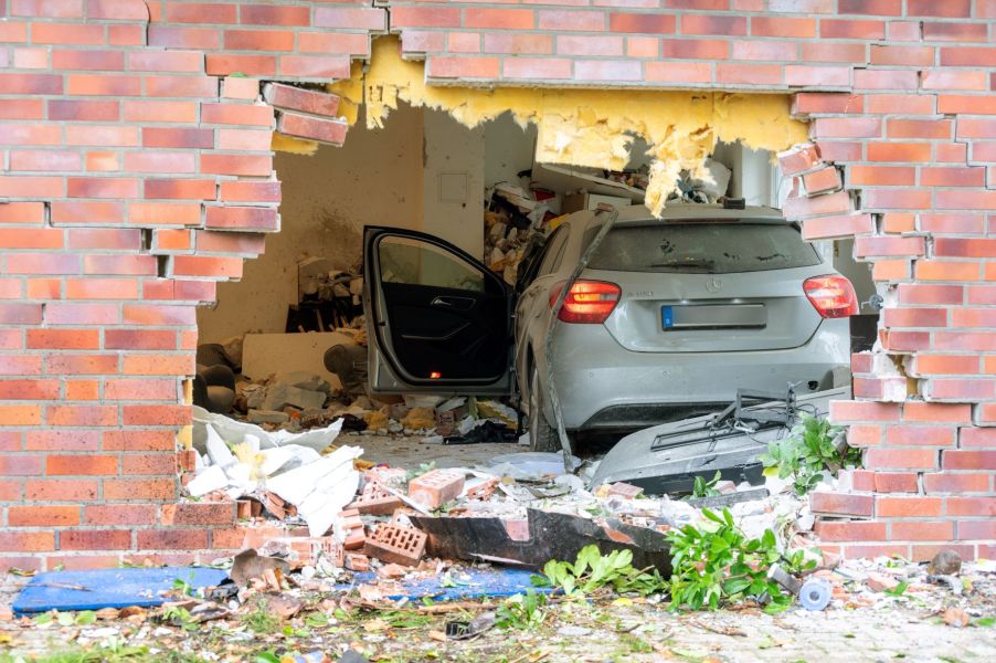 Mercedes-Benz car driven through the wall of an apartment building to show the need to insure a car