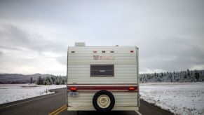 RV, in need of insulation, driving through the snow.