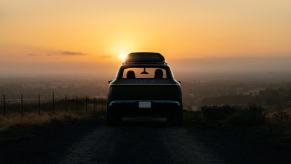 Rear view of Lucid Gravity electric crossover SUV with the sunset in the background