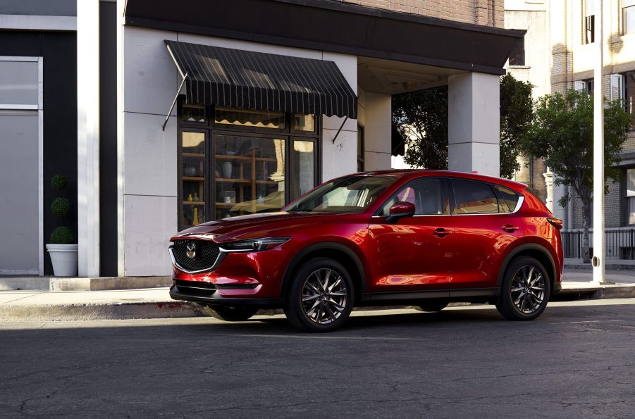 Red 2022 Mazda CX-5 parked near a white building