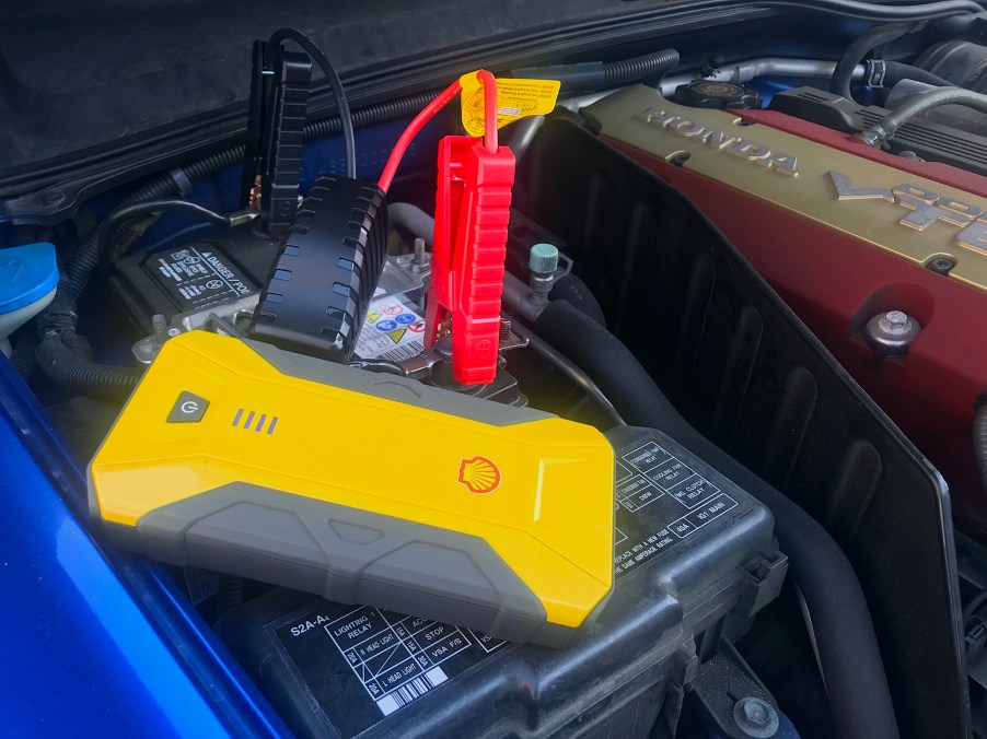 The Shell SH912 jump starter connected to a car battery