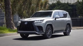 Silver 2022 Lexus LX 600 driving down a street