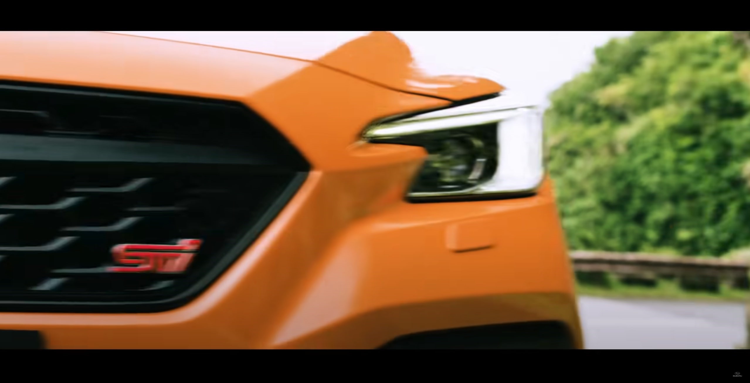 The front grille of the orange 2022 Subaru WRX STI S4