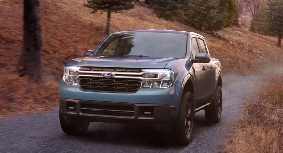 A blue 2022 Ford Maverick driving through the woods, it has one of two engine options.