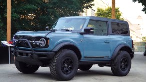 A blue Ford Bronco is on display.