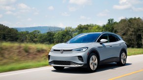 Volkswagen ID.4 EV in light grey paint parked on a rural road