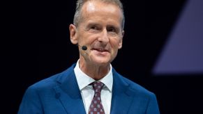 Volkswagen's CEO dressed in a blue suit with a red tie with diamonds on it.