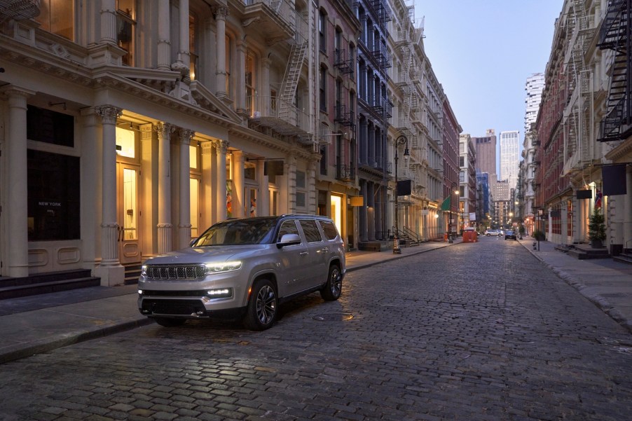 This is a publicity photo of a 2022 Grand Wagoneer parked in the city. The new Luxury SUV did surpisingly well in a head-to-head with the Rolls Royce Cullinan. | Stellantis