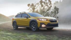 Yellow 2021 Subaru Crosstrek driving on a dirt road