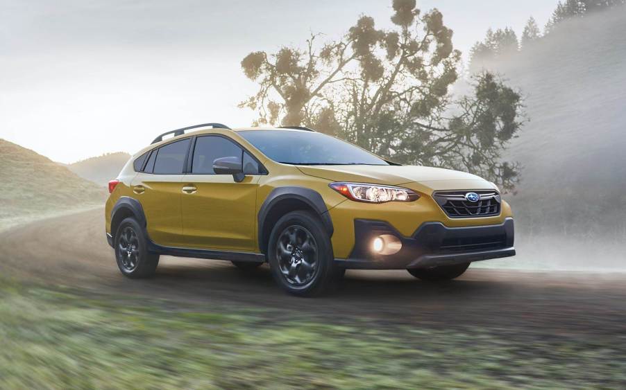 Yellow 2021 Subaru Crosstrek driving on a dirt road