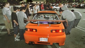 Acura Integra surrounded by kids