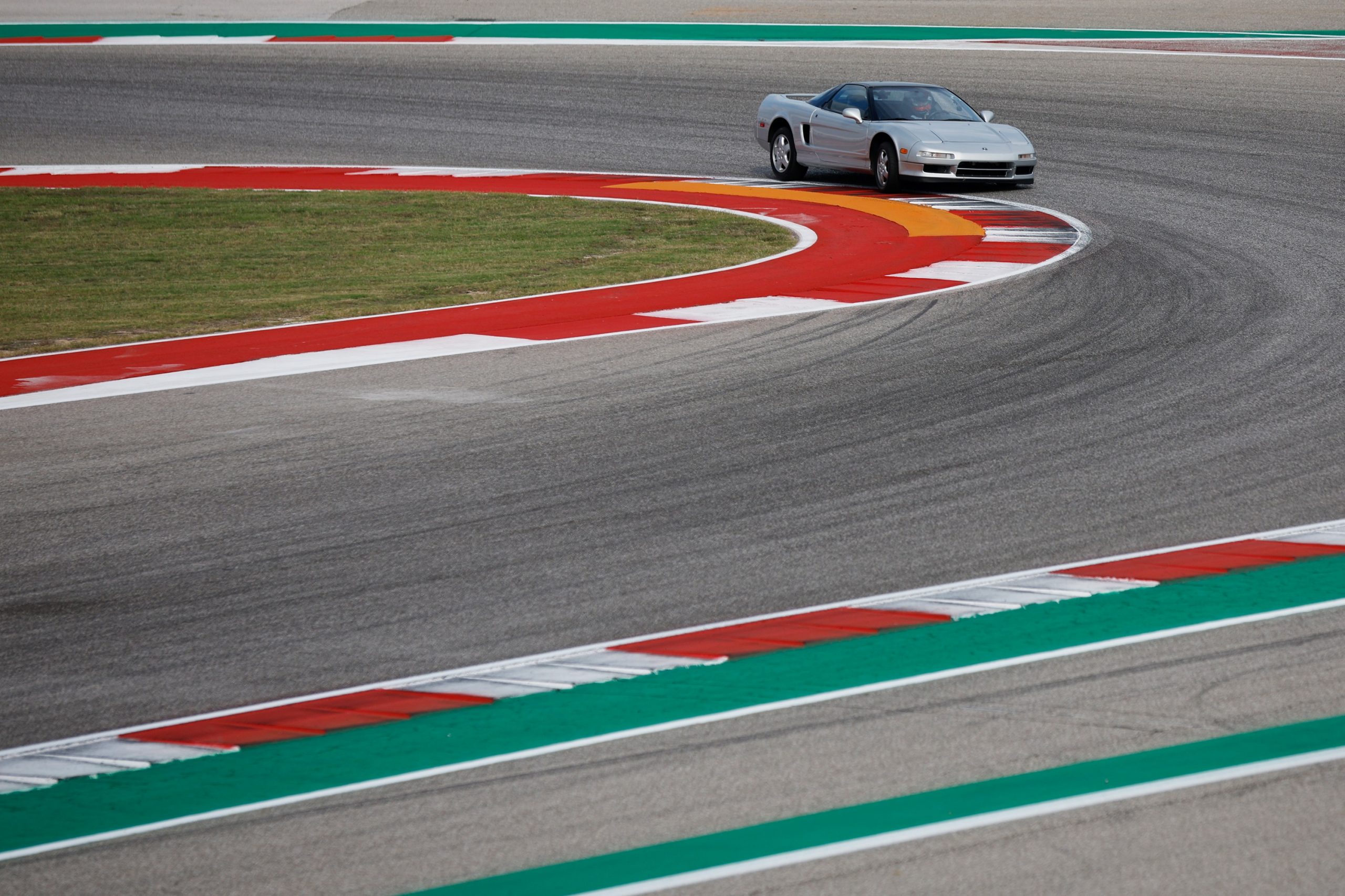 Pierre Gasly at the wheel of a silver NSX