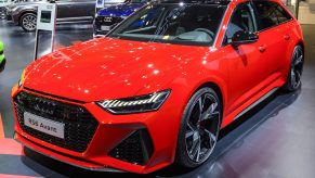 A red Audi RS6 Avant shot from the front 3/4 at an auto show