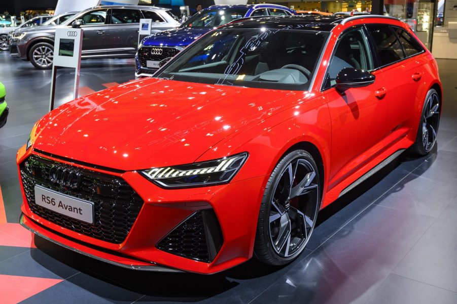 A red Audi RS6 Avant shot from the front 3/4 at an auto show