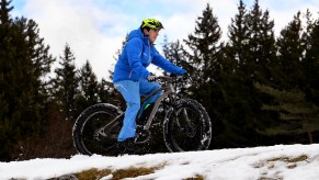 a man rides an electric bike in the snow