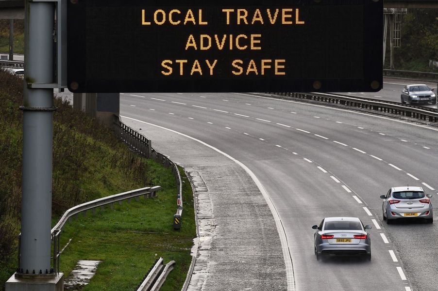 Cars passing a highway traffic safety sign in Glasgow, Scotland