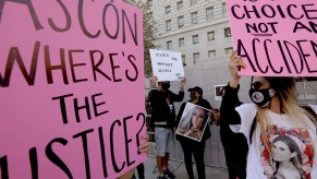 Around 40 family and friends of Monique Munoz attend a rally to call for justice in her death in front of L.A. District Attorney George Gascons office at the Hall of Justice in downtown Los Angeles on March 19, 2021. Munoz, 32, was killed in a car accident where a 17-year-old was driving 120 mph before crashing into her car. Munoz was driving home on Olympic Boulevard and Overland Avenue in Los Angeles when she was hit and killed. The boy, who is the son of Beverly Hills millionaire James Khuri, was booked on vehicular manslaughter in a Lamborghini crash Feb. 23 according to the Los Angeles Police Department but he was not charged.