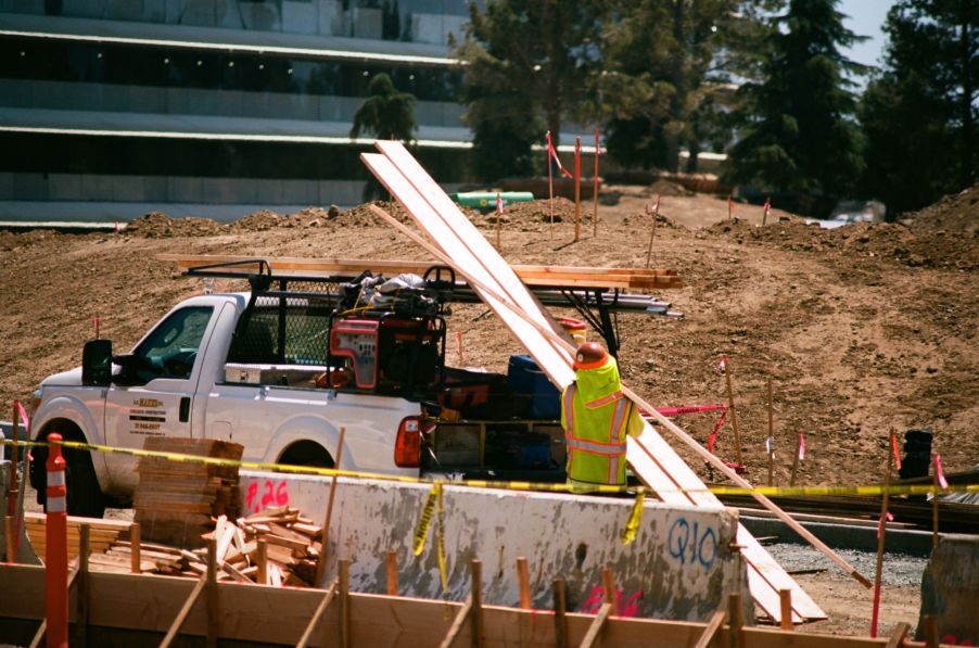 A construction worker loading up a pickup truck with equipment and materials