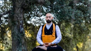 A monk meditating in the woods