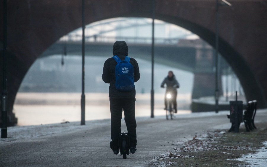 A man on an electric unicycle on the banks of the river Main in Frankfurt am Main, Germany