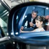 Two ladies learn about the Audi TT from a car salesperson